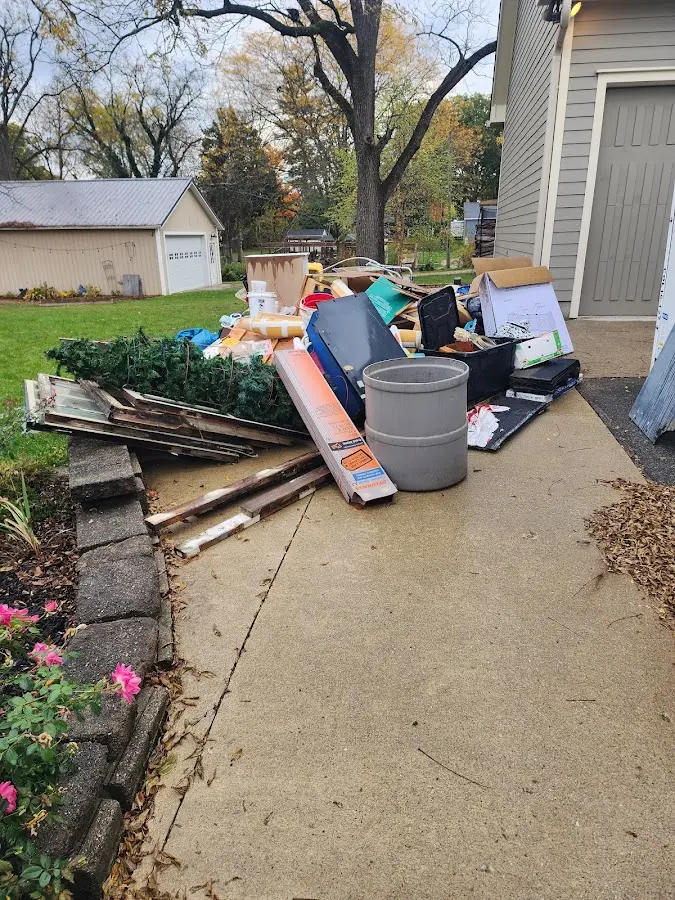 Dumpster being loaded with debris for 12 Yard Dumpster Rental in Livingston